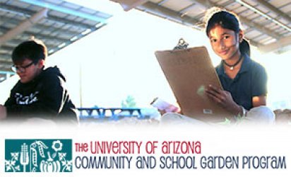 At the center of focus, a young girl holding a clipboard, the sun shining bright behind her and brightening her face as she smiles. Another student sits out of focus on the left. They both  sith on garden soil, plants sprouting up in the foreground. The sky is washed out behind them. A white feathered backdrop takes up the lower thrid of the image, The University of Arizona Community and School Garden Program Logo set over the white lower third.