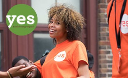 Three Youth Energy Squad participants in orange YES shirts all smiling with the YES logo over the top left corner: Youth Energy Squad Program Logo with "yes" in a green circle over text: Youth Energy Squad.