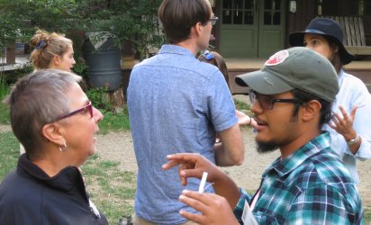 Participants of Maine Environmental Changemakers outdoors in deep discussion.